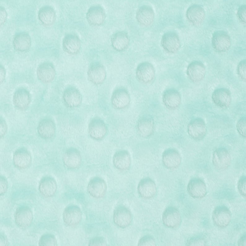 May include: A close-up of a light blue fabric with a textured pattern of small, raised circles.