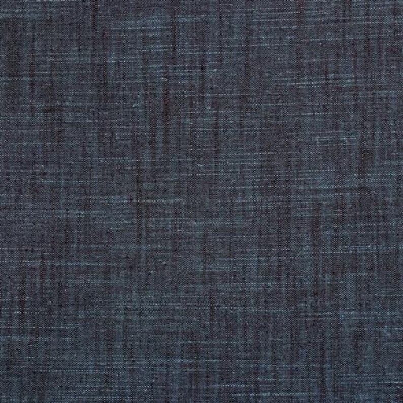 May include: A close-up of a dark blue fabric with a subtle woven texture.