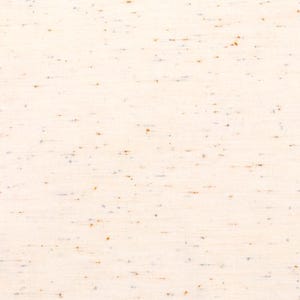 May include: A close-up of a white fabric with a subtle speckled pattern in shades of brown and gray.