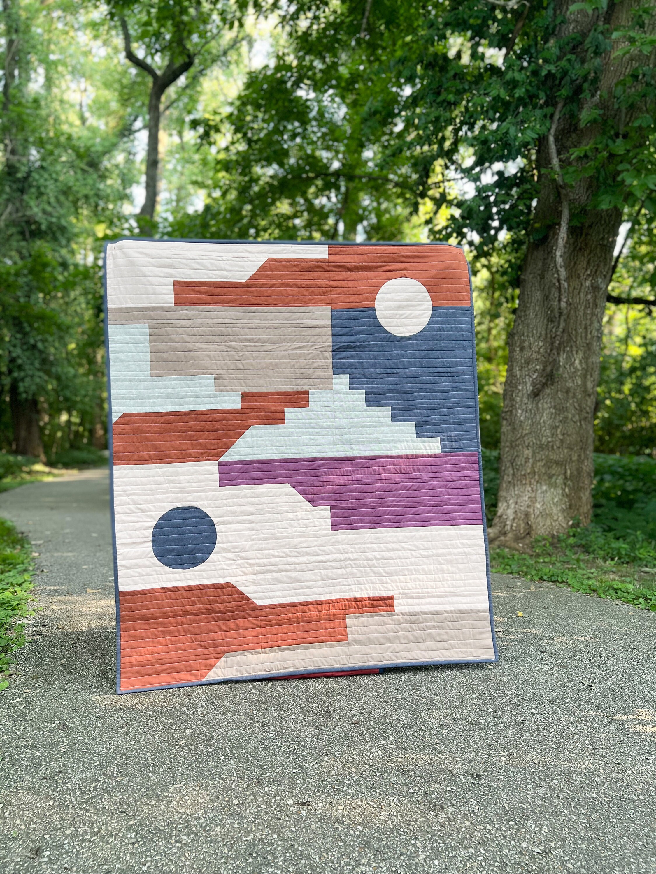Sundance Quilt kit by Wellspring Designs Quilting, featuring poplin, essex linen and sprout wovens in rusty and aubergine earth tones