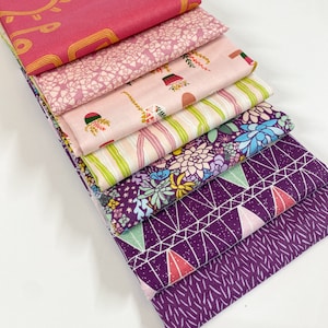 May include: A stack of eight fabric squares in various patterns and colors. The top square is a solid pink with a gold geometric design. The other squares feature floral, geometric, and abstract patterns in shades of pink, purple, and green.