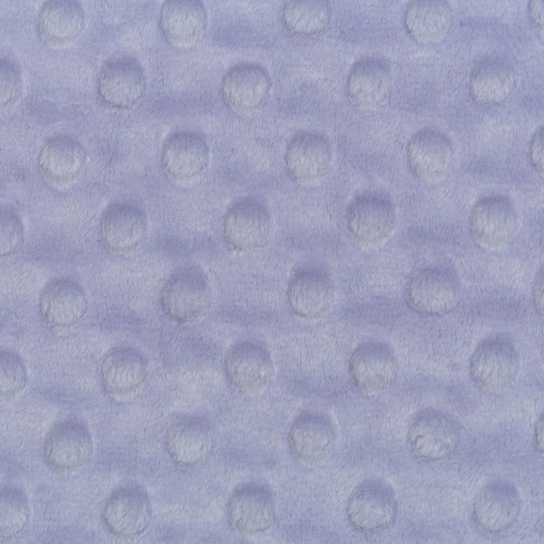 May include: A close-up of a light purple fabric with a textured pattern of small, raised circles.