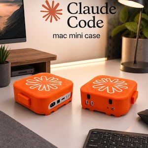 May include: Two orange mac mini cases with white floral designs on top. The cases have various ports and are labeled "Claude Code mac mini case". A keyboard and mouse are in the foreground.