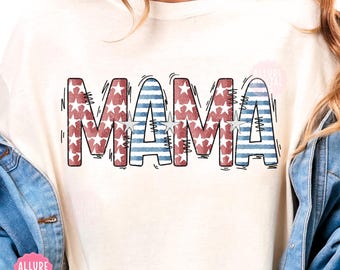 May include: Cream-colored sweatshirt with the word "MAMA" in red, white, and blue. The letters are filled with a star and stripe pattern, with a black outline. The sweatshirt has a casual, patriotic theme.
