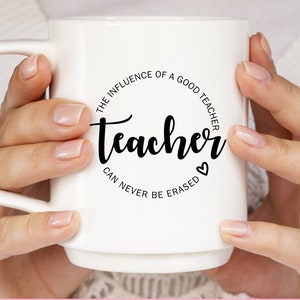May include: White hoodie and mug with a black circle design that says "The influence of a good teacher can never be erased" with the word "teacher" in a larger font.