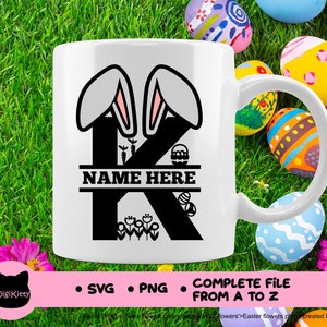May include: White ceramic mug with a black silhouette of the letter K decorated with bunny ears, flowers, and Easter eggs. The text "NAME HERE" is written on a banner above the letter.