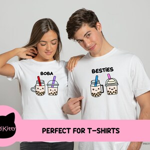 May include: Two white t-shirts with a boba tea design. One shirt says "Boba" and the other says "Besties".