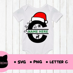 May include: White baby onesie with a black letter C decorated with a red Santa hat, green lights, a snowflake, a reindeer, and a Christmas ornament. The text "NAME HERE" is written in green on a white banner.