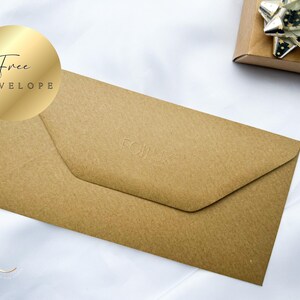 May include: A brown envelope with the word "FOIL" embossed on the front. A gold sticker with the words "Free Envelope" is in the upper left corner. A gift box with a silver bow is in the background.