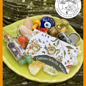 May include: A set of two witchy cat themed earrings with the text "Love you" and "So Matcha" on them. The earrings are displayed on a card with the text "Custom Witchy Wares".