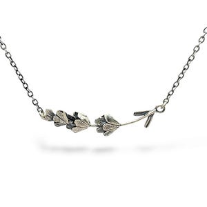 May include: A silver necklace with a delicate floral design. The pendant features a stylized stem with small leaves and flowers.