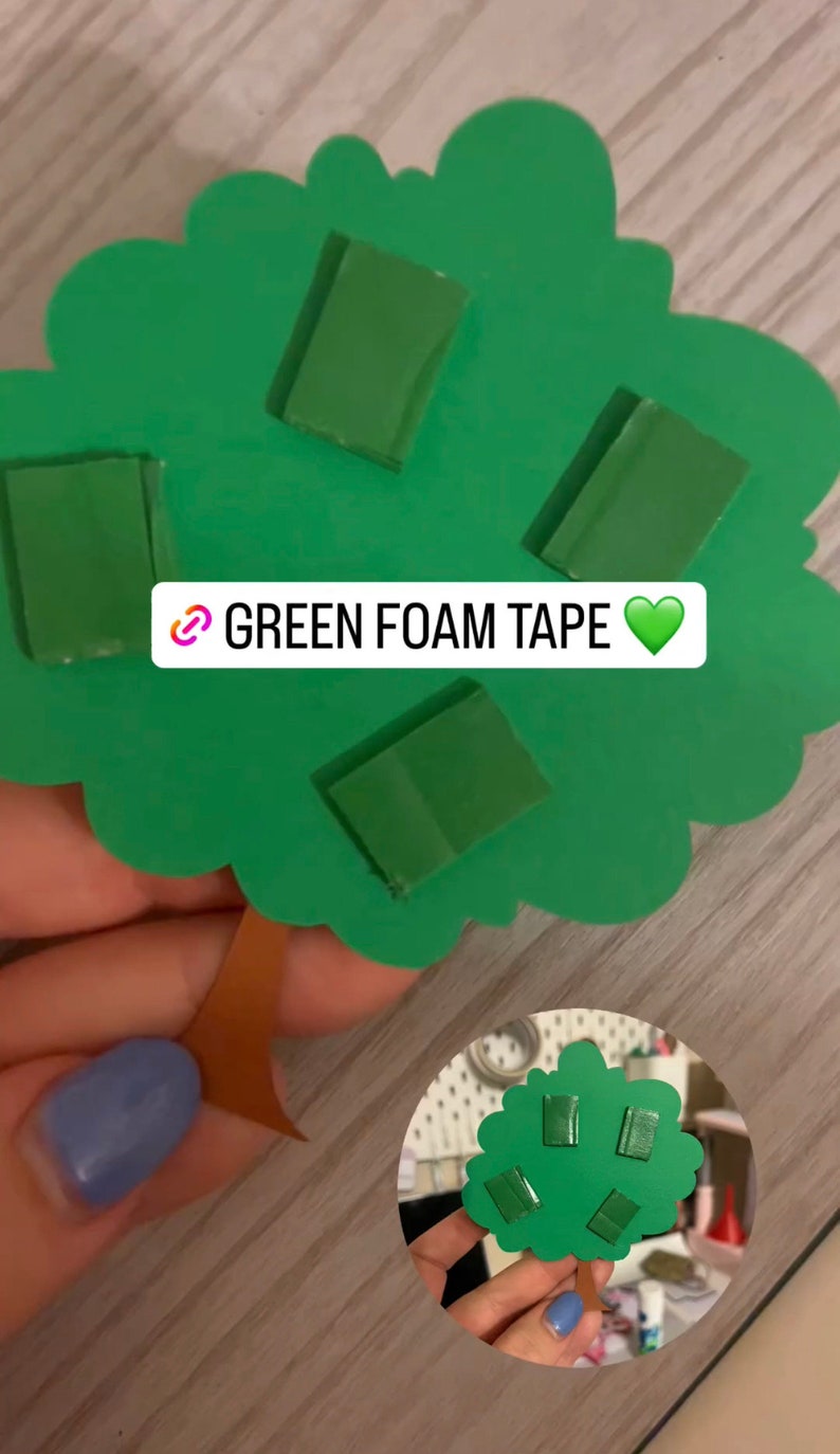 May include: Green foam tape pieces are attached to a green paper tree cutout. The text "GREEN FOAM TAPE" is written on the tree.