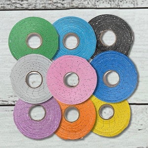 May include: Nine colorful round rolls of tape with different patterns and colors, including green, blue, black, gray, pink, orange, and yellow.