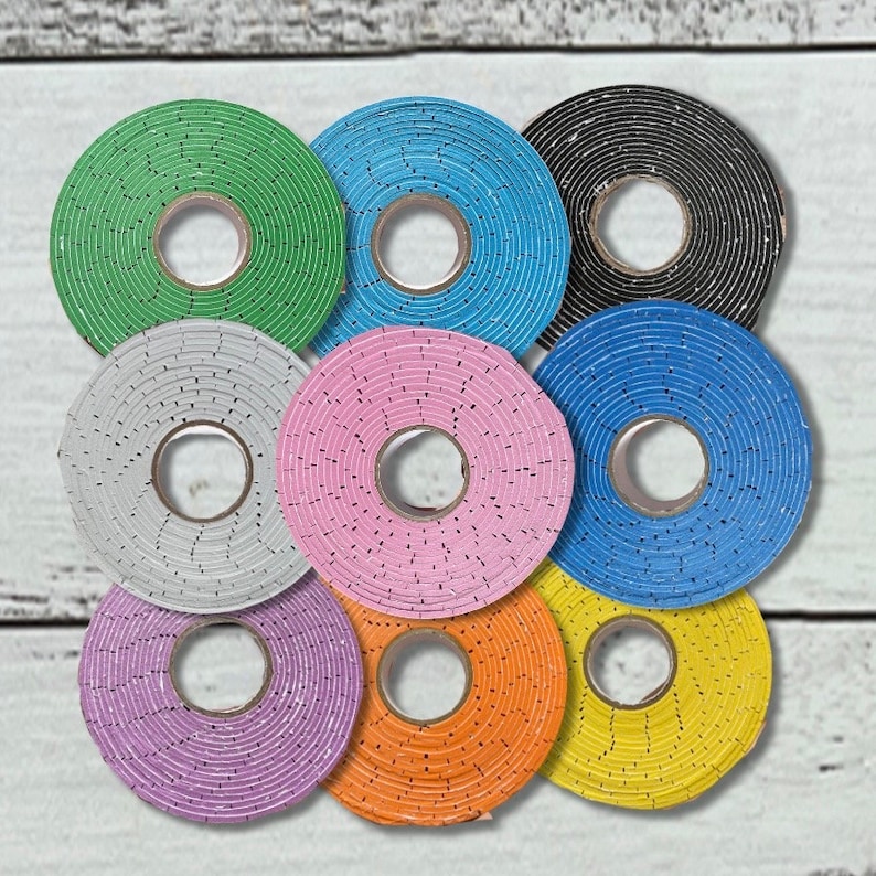May include: Nine colorful round rolls of tape with different patterns and colors, including green, blue, black, gray, pink, orange, and yellow.