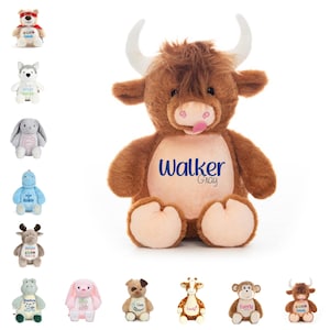 May include: A plush brown Highland cow with white horns, a pink tongue, and the name "Walker Gray" embroidered on its belly. The image also shows several other stuffed animals, including a bear, a husky, a bunny, a dinosaur, a moose, a hippo, a pink bunny, a dog, a giraffe, and a monkey.