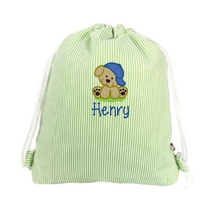 May include: Green and white striped drawstring bag with a cartoon puppy wearing a blue cap. The puppy is embroidered on the front, along with the name "Henry" in blue script. The bag has white drawstrings.