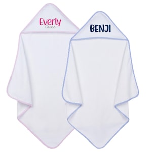 May include: Two white hooded baby towels. One has pink trim and the name "Everly Grace" in pink lettering on the hood. The other has blue trim and the name "BENJI" in blue lettering on the hood. Both towels have a rope-like trim.