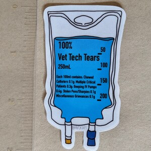 May include: A sticker of a blue IV bag with the text "100% Vet Tech Tears 250mL" and a scale on the side. The text below the bag reads "Each 100ml contains: Chewed Catheters 0.1g: Multiple Critical Patients 0.3g: Beeping IV Pumps 0.4g: Stolen Pens/Sharpies 0.1g Miscellaneous Grievances 0.1g".
