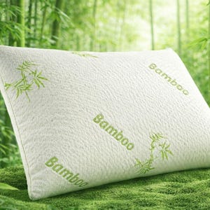May include: A white rectangular pillow with the word "Bamboo" printed in green, and green bamboo leaf designs. The pillow is on green moss, with a bamboo forest in the background.