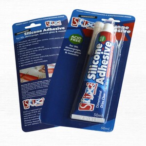 May include: Two packages of Stix2 Silicone Adhesive, a permanent, acid-free adhesive for 3D decoupage, stained glass, and mosaics. The tube contains 50ml of clear adhesive. The packaging is blue and white.