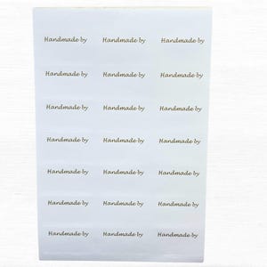 "Selbstklebende ""Handmade By"" Etiketten, vorgeschnittene rechteckige Papieraufkleber mit ""Handmade By"" im Golddruck, 105 Etiketten mit den Maßen 45 mm x 25 mm."