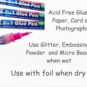 Peut inclure: Trois stylos &agrave; colle rose et bleu avec le texte "2in1 Glue Pen Rolling Ball Acid Free" et "New Pump Action | No Squeezing | Photo Safe | Fine Metal Nib". Le texte "Acid Free Glue for Paper, Card and Photographs" est &eacute;crit sous les stylos &agrave; colle. Le texte "Use Glitter, Embossing Powder and Micro Beads when wet" et "Use with foil when dry" est &eacute;crit sous les stylos &agrave; colle.