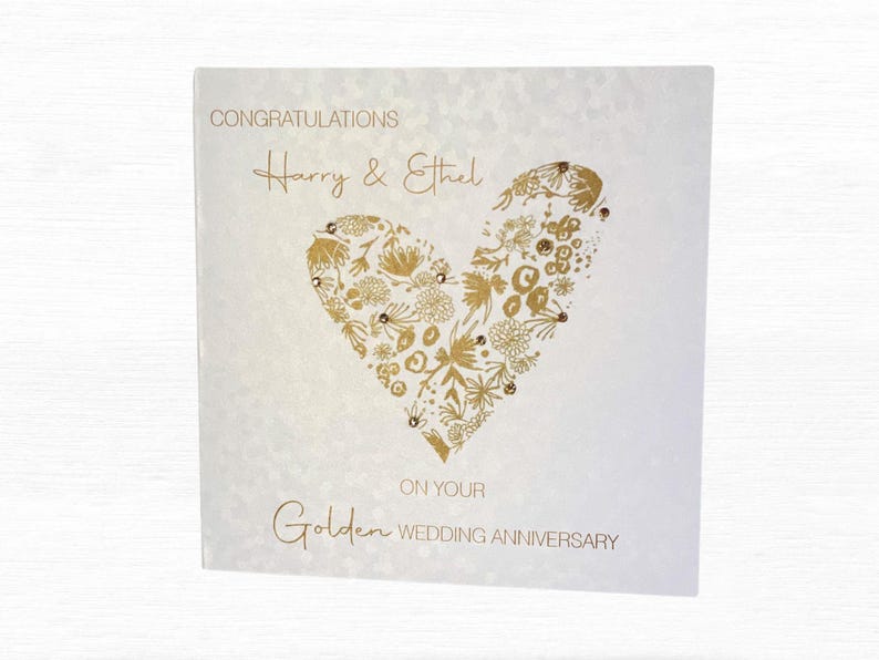 Golden Wedding Anniversary card printed on sequin-effect pearlescent card, featuring a floral gold heart design and personalised names, hand finished with sparkling gold diamantes.