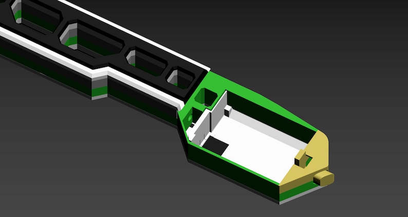 Pode incluir: Um modelo 3D de um objeto preto e branco com um interior verde e dourado. O objeto tem uma s&eacute;rie de furos hexagonais na parte superior e um interior oco.