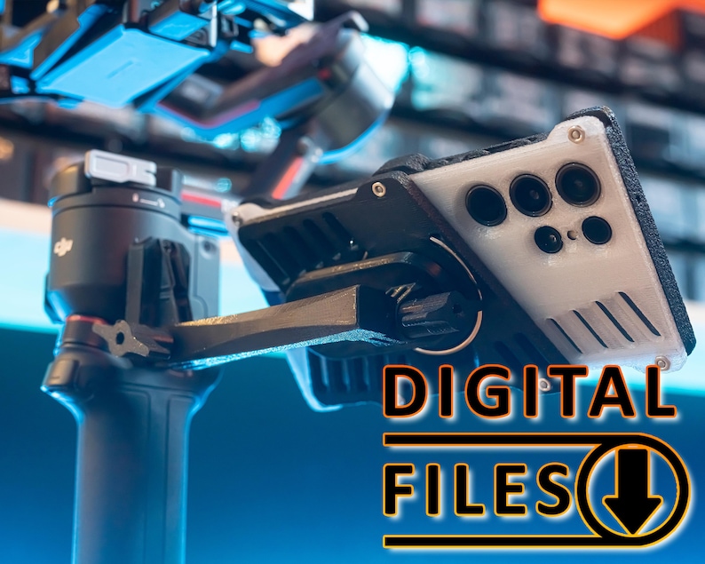 May include: A black and grey phone case with a built-in camera lens protector. The case is attached to a black gimbal with a red lever. The text "DIGITAL FILES" is visible in the lower right corner of the image.