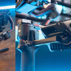 May include: A black camera with a lens attached is mounted on a black and red camera stabiliser. The camera is pointed towards a small screen attached to the stabiliser. The stabiliser is on a tripod. A second image shows a white smartphone with a black case attached to a black camera stabiliser.