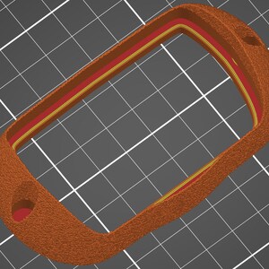 May include: A brown leather key fob with a red and yellow trim. The fob has a keyhole on the side.