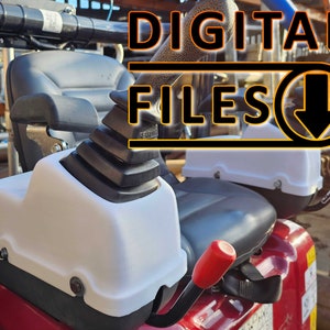 May include: A close-up of a white plastic cover for a forklift control lever. The cover is made of durable plastic and has a smooth, white finish. The lever is black and has a red handle.