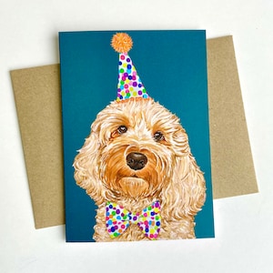 May include: A birthday card featuring a cute, light brown dog wearing a colourful party hat and a bow tie. The dog is against a teal background.