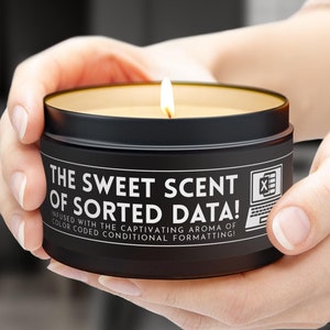 May include: A black candle with a white label that reads "THE SWEET SCENT OF SORTED DATA!"  INFUSED WITH THE CAPTIVATING AROMA OF COLOR CODED CONDITIONAL FORMATTING!"