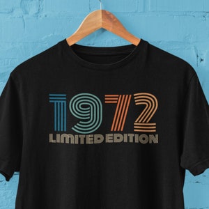 May include: Black t-shirt with a vintage-style graphic of the year 1972 in orange, blue, and yellow stripes. The text "LIMITED EDITION" is printed below the year.