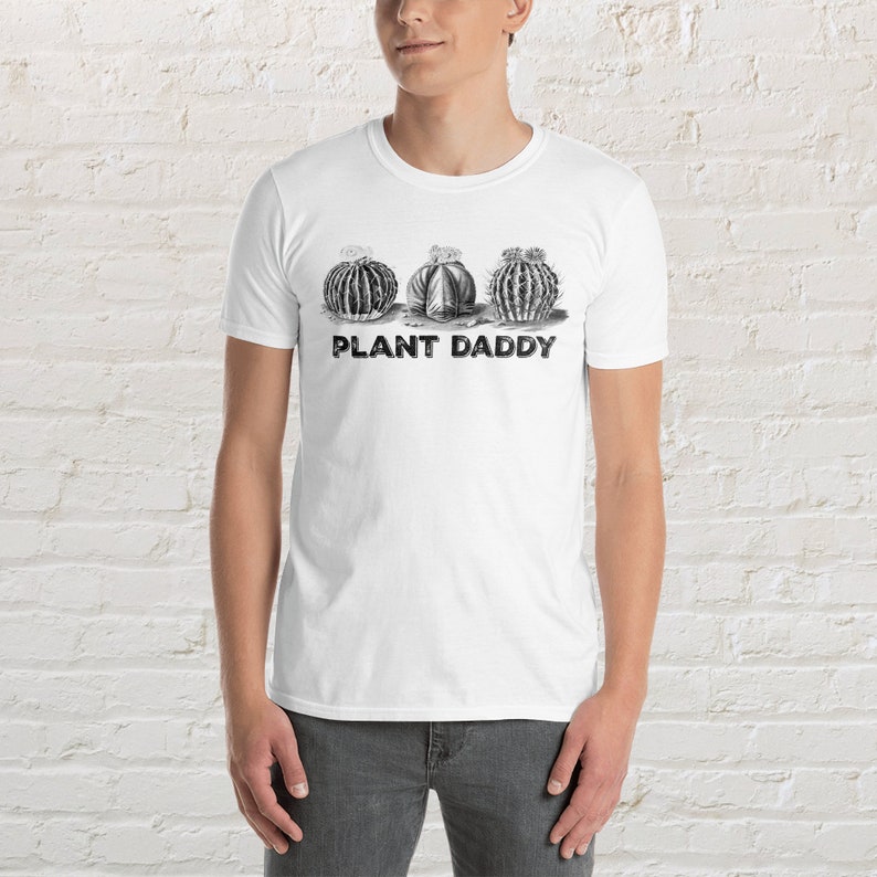 May include: White t-shirt with a black and white illustration of three cacti and the text "PLANT DADDY" printed on the front.