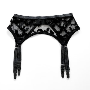 May include: Black lace suspender belt with adjustable straps and metal clips.
