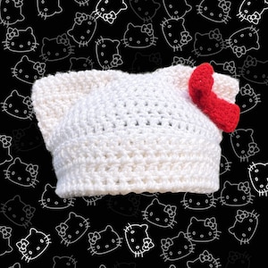white cat ear beanie with red bow | handmade crochet kitty hat | slow fashion hello kitty-inspired cat beanie