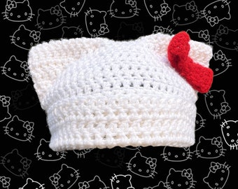 white cat ear beanie with red bow | handmade crochet kitty hat | slow fashion hello kitty-inspired cat beanie