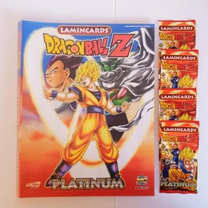 May include: A Dragon Ball Z Lamincards Platinum collection binder featuring illustrations of Goku, Vegeta, and Piccolo on the cover, accompanied by four sealed red and yellow foil trading card booster packs with matching branding and character artwork.