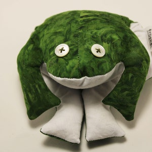 May include: Green frog plush toy with white legs and two white buttons for eyes. The toy has a tag that says "frookee".