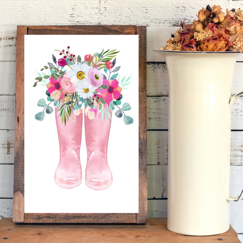 K&ouml;nnte beinhalten: Ein Aquarellbild von rosa Gummistiefeln mit einem Strau&szlig; rosa, wei&szlig;er und gr&uuml;ner Blumen.