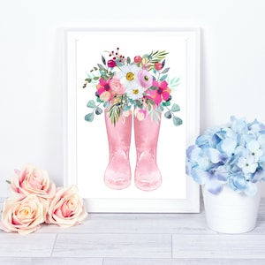 K&ouml;nnte beinhalten: Ein Aquarellbild von rosa Gummistiefeln mit einem Strau&szlig; rosa, wei&szlig;er und gr&uuml;ner Blumen.