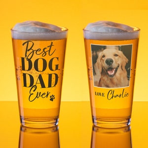 May include: Two pint glasses filled with beer and foam. One glass has the text "Best DOG DAD Ever" and a paw print. The other glass has a photo of a golden retriever and the text "Love Charlie".