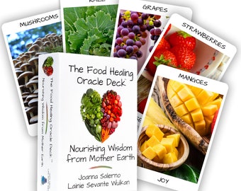 May include: The Food Healing Oracle Deck box features a heart-shaped collage of colorful vegetables and fruits. Surrounding the box are five cards labeled Mushrooms, Kale, Grapes, Strawberries, and Mangoes, each displaying a photograph of the food.