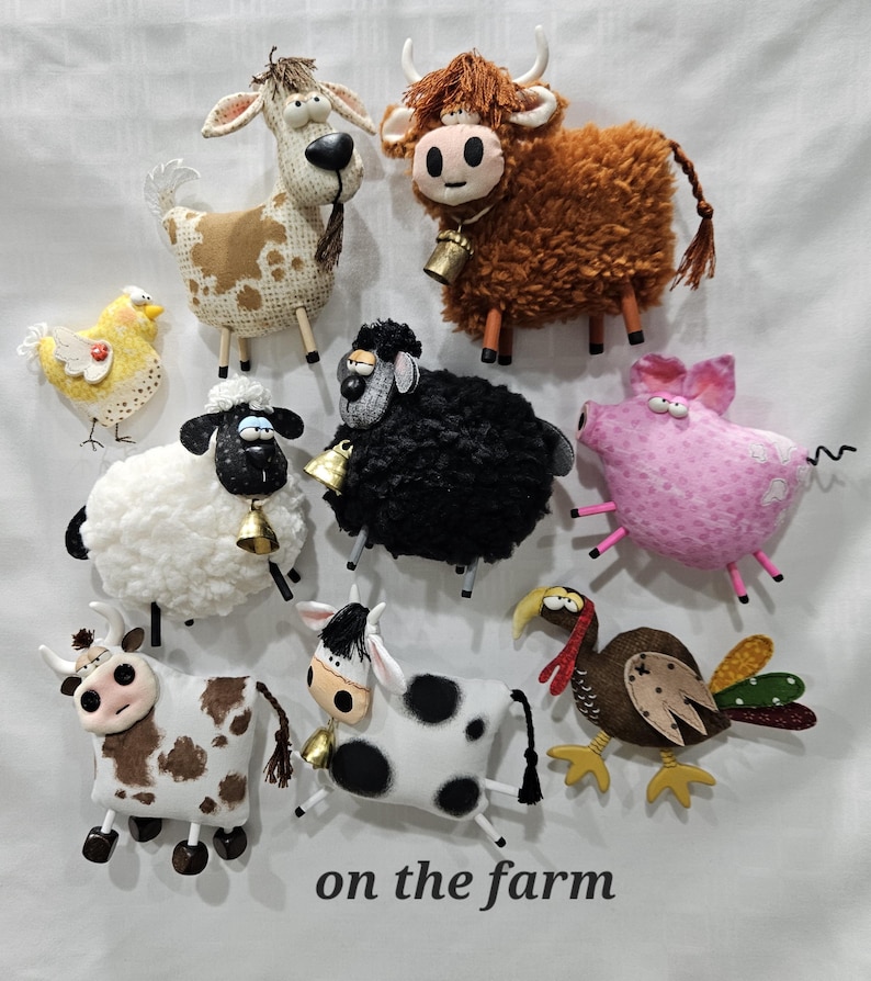 May include: A collection of handmade farm animal figurines, including cows, sheep, a pig, a turkey, and a chicken. The figurines are made of fabric and have detailed features. The text "on the farm" is at the bottom.