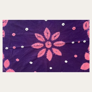 May include: Purple fabric with a pink flower design and white polka dots.