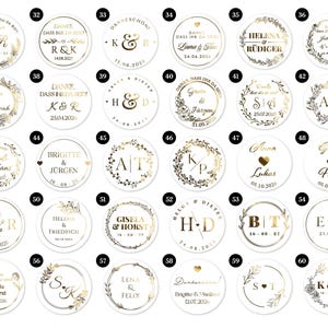 May include: A collection of white, round stickers with gold foil accents. Each sticker features names, initials, and dates, surrounded by decorative elements like wreaths and floral designs. The stickers are likely for weddings or special events.