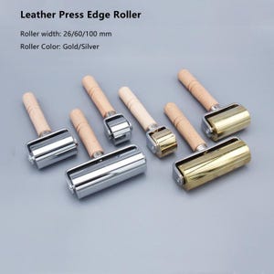 May include: Several leather press edge rollers with wooden handles and metal rollers. The rollers are available in gold and silver colors, with widths of 26, 60, and 100 mm. The text "Leather Press Edge Roller" is at the top.