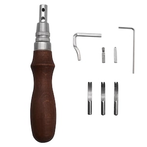 May include: A leathercraft tool set featuring a wooden-handled stitching awl with a metal tip, accompanied by various metal tools, including a curved wrench, a straight wrench, and three different sized slot punches. The tools are arranged on a white background.